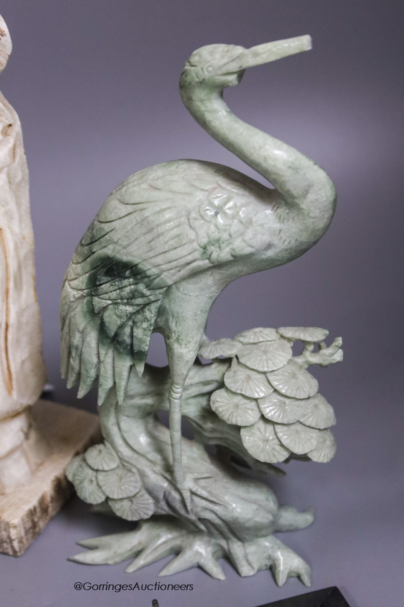 A large marble lion's paw, an alabaster monk, a soapstone crane and a white metal model of The Queen Mary ship
